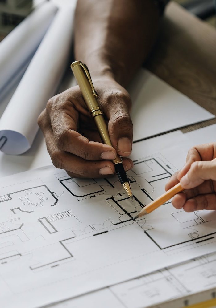 Team construction engineers working at construction site with blueprint on table